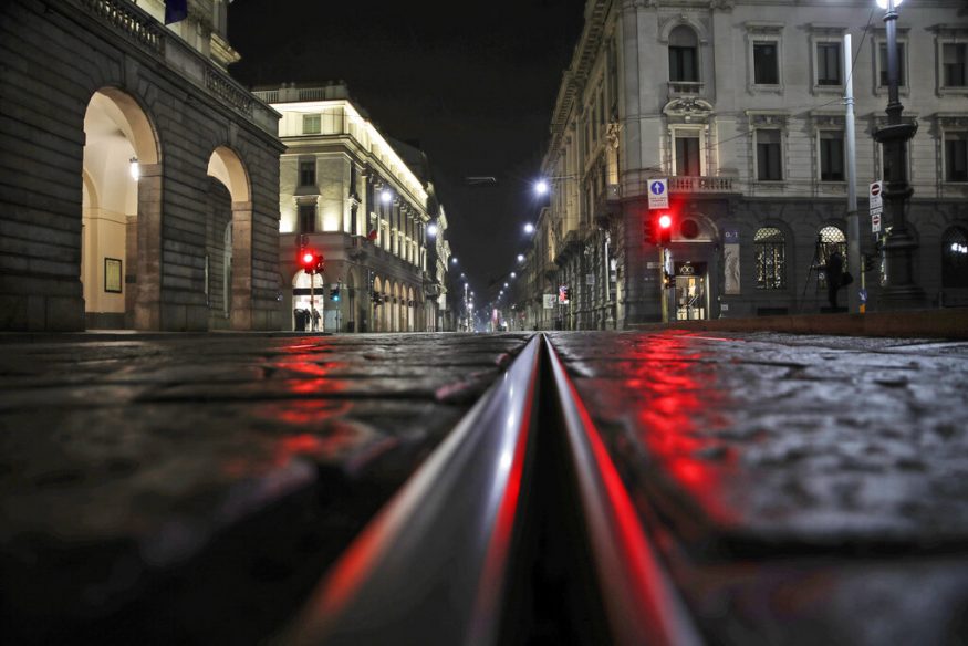  An empty street in front of La Scala opera house is lit by a red traffic light in Milan, Italy. (Image: AP)