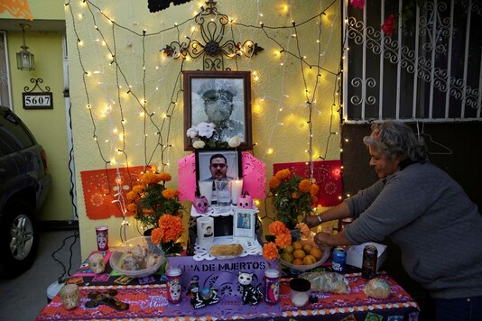 The mother of Andres Garcia Gonzalez, a nurse from the Mexican Institute of Social Security (IMSS) who died of the coronavirus disease (COVID-19), makes an altar to honor her son ahead of the Day of the Dead, in Ciudad Juarez, Mexico October 29, 2020. REUTERS/Jose Luis Gonzalez