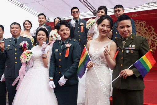 Two same-sex couples take a group photo during a military mass wedding in Taoyuan, Taiwan, October 30, 2020. REUTERS/Ann Wang
