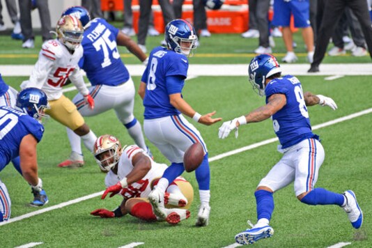 New York Giants quarterback Daniel Jones, center, and San Francisco 49ers' Kevin Givens (90) looks after a loose ball during the first half of an NFL football game, Sunday, Sept. 27, 2020, in East Rutherford, N.J. (AP Photo/Bill Kostroun)