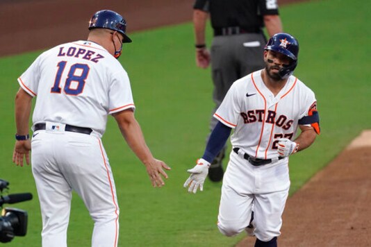 Houston Astros' Jose Altuve is congratulated by third base coach Omar Lopez after hitting a solo home run against against the Tampa Bay Rays starting pitcher Ryan Yarbrough during the first inning in Game 3 of a baseball American League Championship Series, Tuesday, Oct. 13, 2020, in San Diego. (AP Photo/Ashley Landis) Houston Astros' Jose Altuve is congratulated by third base coach Omar Lopez after hitting a solo home run against against the Tampa Bay Rays starting pitcher Ryan Yarbrough during the first inning in Game 3 of a baseball American League Championship Series, Tuesday, Oct. 13, 2020, in San Diego. (AP Photo/Ashley Landis)