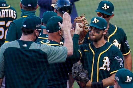 Oakland Athletics' Chad Pinder, right, celebrates with manager Bob Melvin after the Athletics defeated the Houston Astros in Game 3 of a baseball American League Division Series in Los Angeles, Wednesday, Oct. 7, 2020. (AP Photo/Marcio Jose Sanchez) Oakland Athletics' Chad Pinder, right, celebrates with manager Bob Melvin after the Athletics defeated the Houston Astros in Game 3 of a baseball American League Division Series in Los Angeles, Wednesday, Oct. 7, 2020. (AP Photo/Marcio Jose Sanchez)