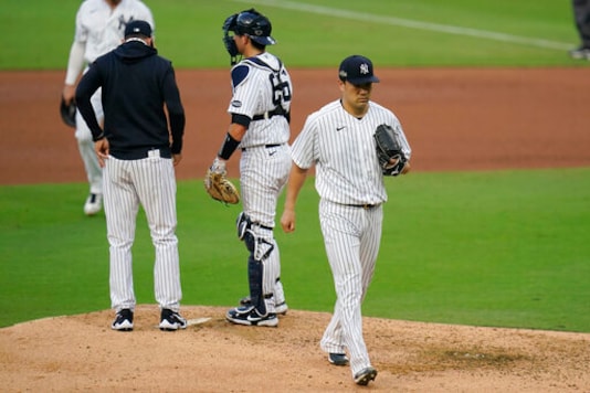 New York Yankees starting pitcher Masahiro Tanaka, right, leaves the game during the fifth inning in Game 3 of a baseball American League Division Series against the Tampa Bay Rays, Wednesday, Oct. 7, 2020, in San Diego. (AP Photo/Gregory Bull) New York Yankees starting pitcher Masahiro Tanaka, right, leaves the game during the fifth inning in Game 3 of a baseball American League Division Series against the Tampa Bay Rays, Wednesday, Oct. 7, 2020, in San Diego. (AP Photo/Gregory Bull)