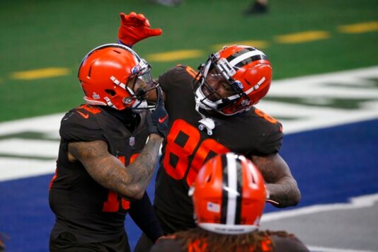 Cleveland Browns wide receiver Odell Beckham Jr. (13), wide receiver Jarvis Landry (80) and others celebrate Beckham's touchdown late in the second half of an NFL football game against the Dallas Cowboys in Arlington, Texas, Sunday, Oct. 4, 2020. (AP Photo/Michael Ainsworth)