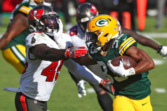 Green Bay Packers running back Aaron Jones (33) stiff arms Tampa Bay Buccaneers inside linebacker Devin White (45) during the first half of an NFL football game Sunday, Oct. 18, 2020, in Tampa, Fla. (AP Photo/Mark LoMoglio)