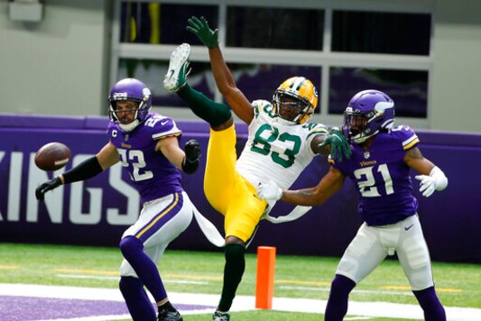 Minnesota Vikings free safety Harrison Smith (22) and cornerback Mike Hughes (21) break up a pass intended for Green Bay Packers wide receiver Marquez Valdes-Scantling (83) during the first half of an NFL football game, Sunday, Sept. 13, 2020, in Minneapolis. (AP Photo/Bruce Kluckhohn)