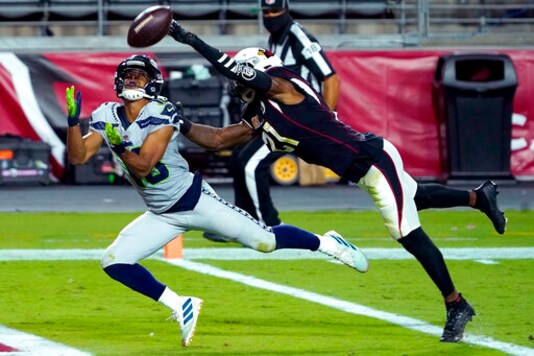 Seattle Seahawks wide receiver Tyler Lockett, left, pulls in a touchdown catch as Arizona Cardinals cornerback Patrick Peterson defends during the first half of an NFL football game, Sunday, Oct. 25, 2020, in Glendale, Ariz. (AP Photo/Rick Scuteri)