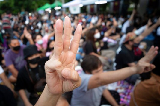 Pro-democracy activists flash three-fingered salutes outside remand prison, in which some of the activists are kept in Bangkok, Thailand, Friday, Oct. 23, 2020. Thailand's government on Thursday canceled a state of emergency it had declared last week for Bangkok in a gesture offered by the embattled prime minister to cool student-led protests seeking democracy reforms. (AP Photo/Sakchai Lalit) Pro-democracy activists flash three-fingered salutes outside remand prison, in which some of the activists are kept in Bangkok, Thailand, Friday, Oct. 23, 2020. Thailand's government on Thursday canceled a state of emergency it had declared last week for Bangkok in a gesture offered by the embattled prime minister to cool student-led protests seeking democracy reforms. (AP Photo/Sakchai Lalit)