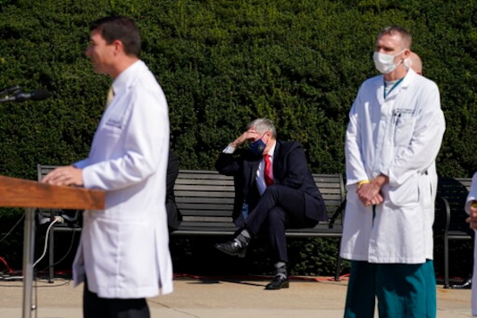 White House Chief of Staff Mark Meadows, seated center, listens as Dr. Sean Conley, physician to President Donald Trump, briefs reporters at Walter Reed National Military Medical Center in Bethesda, Md., Sunday, Oct. 4, 2020. Trump was admitted to the hospital after contracting the coronavirus. (AP Photo/Jacquelyn Martin) White House Chief of Staff Mark Meadows, seated center, listens as Dr. Sean Conley, physician to President Donald Trump, briefs reporters at Walter Reed National Military Medical Center in Bethesda, Md., Sunday, Oct. 4, 2020. Trump was admitted to the hospital after contracting the coronavirus. (AP Photo/Jacquelyn Martin)