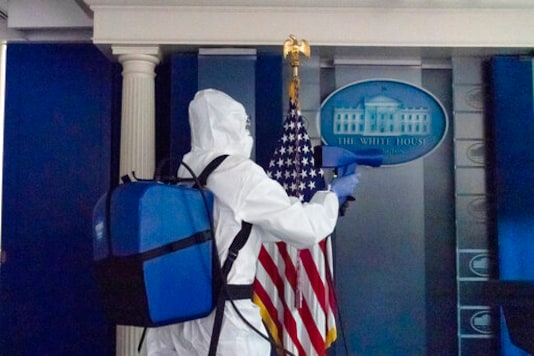 A member of the cleaning staff sprays The James Brady Briefing Room of the White House, Monday, Oct. 5, 2020, in Washington. (AP Photo/Alex Brandon) A member of the cleaning staff sprays The James Brady Briefing Room of the White House, Monday, Oct. 5, 2020, in Washington. (AP Photo/Alex Brandon)