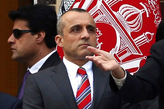 FILE - In this March 9, 2020, file photo, Afghan first Vice President Amrullah Saleh, center, listens to President Ashraf Ghani, addressing at an inauguration ceremony at the presidential palace in Kabul, Afghanistan. A prominent rights group Friday, Oct. 23, demanded the immediate release of a person detained by the government for providing information about an army airstrike this week in which 12 civilians, mostly children, were killed and 18 others were wounded. The order to arrest at least one individual who spoke to media outlets about the Wednesday strike in northern Takhar province was made by Saleh on Thursday. (AP Photo/Rahmat Gul, File) FILE - In this March 9, 2020, file photo, Afghan first Vice President Amrullah Saleh, center, listens to President Ashraf Ghani, addressing at an inauguration ceremony at the presidential palace in Kabul, Afghanistan. A prominent rights group Friday, Oct. 23, demanded the immediate release of a person detained by the government for providing information about an army airstrike this week in which 12 civilians, mostly children, were killed and 18 others were wounded. The order to arrest at least one individual who spoke to media outlets about the Wednesday strike in northern Takhar province was made by Saleh on Thursday. (AP Photo/Rahmat Gul, File)
