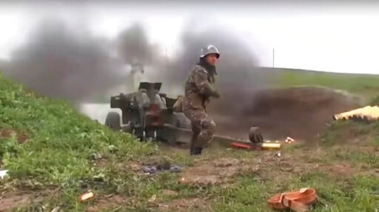 This image taken from a video released by Armenian Defense Ministry on Friday, Oct. 2, 2020 an Armenian serviceman fires a cannon towards Azerbaijan positions at the contact line of the self-proclaimed Republic of Nagorno-Karabakh, Azerbaijan. Clashes broke out Sunday in Nagorno-Karabakh, a region within Azerbaijan that has been controlled by ethnic Armenian forces backed by the Armenian government since the end of a separatist war a quarter-century ago. (Armenian Defense Ministry via AP) This image taken from a video released by Armenian Defense Ministry on Friday, Oct. 2, 2020 an Armenian serviceman fires a cannon towards Azerbaijan positions at the contact line of the self-proclaimed Republic of Nagorno-Karabakh, Azerbaijan. Clashes broke out Sunday in Nagorno-Karabakh, a region within Azerbaijan that has been controlled by ethnic Armenian forces backed by the Armenian government since the end of a separatist war a quarter-century ago. (Armenian Defense Ministry via AP)