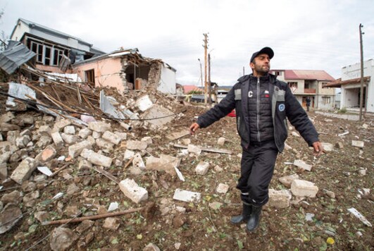 A man gestures near a house destroyed by shelling by Azerbaijan's artillery during a military conflict in Stepanakert, self-proclaimed Republic of Nagorno-Karabakh, Thursday, Oct. 8, 2020. Armenia accused Azerbaijan of firing missiles into the capital of the separatist territory of Nagorno-Karabakh, while Azerbaijan said several of its towns and its second-largest city were attacked. (AP Photo) A man gestures near a house destroyed by shelling by Azerbaijan's artillery during a military conflict in Stepanakert, self-proclaimed Republic of Nagorno-Karabakh, Thursday, Oct. 8, 2020. Armenia accused Azerbaijan of firing missiles into the capital of the separatist territory of Nagorno-Karabakh, while Azerbaijan said several of its towns and its second-largest city were attacked. (AP Photo)
