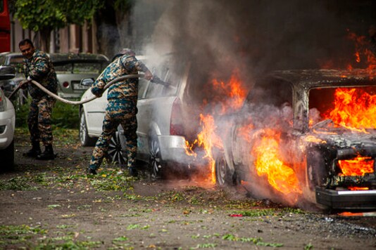 Firefighters work on a car burning, after shelling by Azerbaijan's artillery in Stepanakert, the self-proclaimed Republic of Nagorno-Karabakh, Azerbaijan, Sunday, Oct. 4, 2020. Heavy fighting between Azerbaijani and Armenian forces in the region since Sept. 27 has killed scores of both servicemen and civilians. Nagorno-Karabakh lies inside Azerbaijan but has been under the control of ethnic Armenian forces backed by Armenia since the 1994. (AP Photo/Karen Mirzoyan) Firefighters work on a car burning, after shelling by Azerbaijan's artillery in Stepanakert, the self-proclaimed Republic of Nagorno-Karabakh, Azerbaijan, Sunday, Oct. 4, 2020. Heavy fighting between Azerbaijani and Armenian forces in the region since Sept. 27 has killed scores of both servicemen and civilians. Nagorno-Karabakh lies inside Azerbaijan but has been under the control of ethnic Armenian forces backed by Armenia since the 1994. (AP Photo/Karen Mirzoyan)