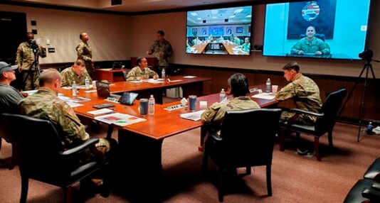 In this image provided by the U.S. Army, panelists listen to a U.S. Army soldier pitch his idea during the inaugural Dragon Innovation Challenge at Fort Bragg, N.C., on Tuesday, Oct. 27, 2020. The Shark Tank like competition is aimed at sourcing new ideas from untapped areas of the Army. (U.S. Army via AP) In this image provided by the U.S. Army, panelists listen to a U.S. Army soldier pitch his idea during the inaugural Dragon Innovation Challenge at Fort Bragg, N.C., on Tuesday, Oct. 27, 2020. The Shark Tank like competition is aimed at sourcing new ideas from untapped areas of the Army. (U.S. Army via AP)
