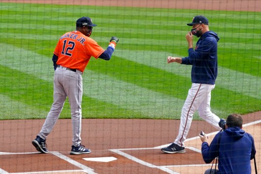 Minnesota Twins manager Rocco Baldelli, right, and Houston Astros manager Dusty Baker, Jr. greet each other before the first inning of an American League wild-card series baseball game Tuesday, Sept 29, 2020, in Minneapolis. (AP Photo/Jim Mone)