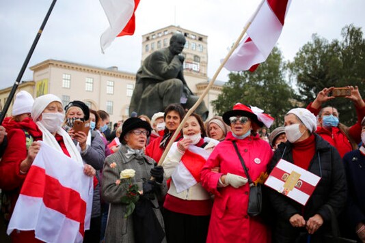 People, most of them pensioners, hold old Belarusian national flags march during an opposition rally to protest the official presidential election results in Minsk, Russia, Monday, Oct. 26, 2020. Factory workers, students and business owners in Belarus have started a general strike, calling for authoritarian President Alexander Lukashenko to resign after more than two months of mass protests triggered by a disputed election. (AP Photo)
