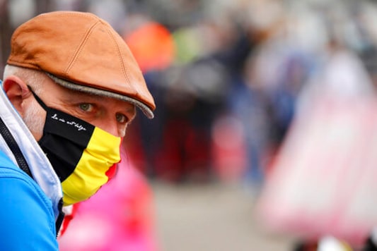 A spectator wears a protective mask as he watches the Belgian cycling classic and UCI World Tour race Fleche Wallonne, in Huy, Belgium, Wednesday, Sept. 30, 2020. (AP Photo/Olivier Matthys) A spectator wears a protective mask as he watches the Belgian cycling classic and UCI World Tour race Fleche Wallonne, in Huy, Belgium, Wednesday, Sept. 30, 2020. (AP Photo/Olivier Matthys)