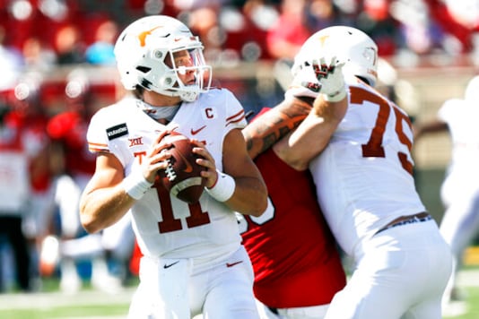 FILE - In this Saturday Sept. 26, 2020, file photo, Texas quarterback Sam Ehlinger looks for an open receiver during the first half of an NCAA college football game against Texas Tech in Lubbock, Texas. No. 22 Texas vs. Oklahoma, at Cotton Bowl Stadium, Dallas. There is no State Fair of Texas this year because of the pandemic and both teams are coming off a loss, but this is still the Red River rivalry. (AP Photo/Mark Rogers, File) FILE - In this Saturday Sept. 26, 2020, file photo, Texas quarterback Sam Ehlinger looks for an open receiver during the first half of an NCAA college football game against Texas Tech in Lubbock, Texas. No. 22 Texas vs. Oklahoma, at Cotton Bowl Stadium, Dallas. There is no State Fair of Texas this year because of the pandemic and both teams are coming off a loss, but this is still the Red River rivalry. (AP Photo/Mark Rogers, File)