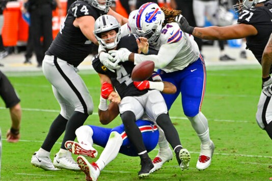 Buffalo Bills defensive tackle Vernon Butler (94) helps take down Las Vegas Raiders quarterback Derek Carr (4) during the second half of an NFL football game, Sunday, Oct. 4, 2020, in Las Vegas. The play was not ruled a fumble. (AP Photo/David Becker)