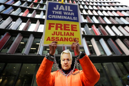 A demonstrator holds a banner and wears a Julian Assange mask opposite the Old Bailey in London, Thursday, Oct. 1, 2020, as the Julian Assange extradition hearing to the US continues. (AP Photo/Kirsty Wigglesworth) A demonstrator holds a banner and wears a Julian Assange mask opposite the Old Bailey in London, Thursday, Oct. 1, 2020, as the Julian Assange extradition hearing to the US continues. (AP Photo/Kirsty Wigglesworth)