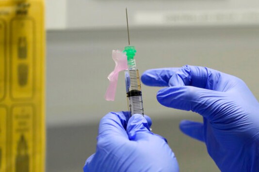 FILE - In this Wednesday, Aug. 5, 2020 file photo, senior Clinical Research Nurse Ajithkumar Sukumaran prepares the COVID 19 vaccine to administer to a volunteer, at a clinic in London. The British government on Thursday, Sept. 24, 2020 says it may take part in a study that tries to deliberately infect volunteers who have been given an experimental vaccine against the coronavirus in an effort to more quickly determine if the vaccine works. The approach, called a challenge study, is risky but proponents think it may produce results faster than typical studies, which wait to see if volunteers who have been given an experimental treatment or a dummy version get sick. (AP Photo/Kirsty Wigglesworth, File) FILE - In this Wednesday, Aug. 5, 2020 file photo, senior Clinical Research Nurse Ajithkumar Sukumaran prepares the COVID 19 vaccine to administer to a volunteer, at a clinic in London. The British government on Thursday, Sept. 24, 2020 says it may take part in a study that tries to deliberately infect volunteers who have been given an experimental vaccine against the coronavirus in an effort to more quickly determine if the vaccine works. The approach, called a challenge study, is risky but proponents think it may produce results faster than typical studies, which wait to see if volunteers who have been given an experimental treatment or a dummy version get sick. (AP Photo/Kirsty Wigglesworth, File)