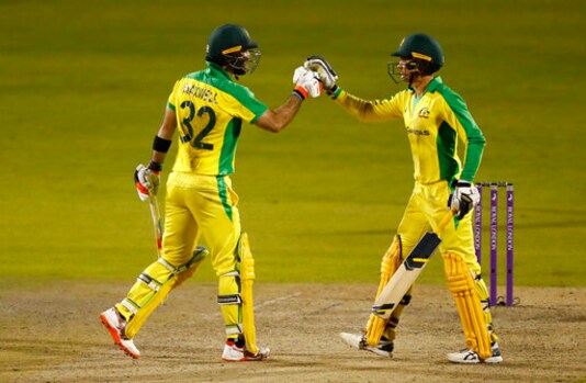 Australia's Glenn Maxwell, left, celebrates with batting partner Alex Carey after scoring a century during the third ODI cricket match between England and Australia, at Old Trafford in Manchester, England, Wednesday, Sept. 16, 2020. (Jason Cairnduff/Pool via AP)