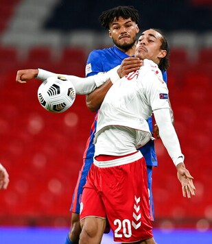 England's Tyrone Mings and Denmark's Yussuf Poulsen battle for the ball during the UEFA Nations League soccer match between England and Denmark at Wembley Stadium in London, England, Wednesday, Oct. 14, 2020. (Daniel Leal-Olivas/Pool via AP) England's Tyrone Mings and Denmark's Yussuf Poulsen battle for the ball during the UEFA Nations League soccer match between England and Denmark at Wembley Stadium in London, England, Wednesday, Oct. 14, 2020. (Daniel Leal-Olivas/Pool via AP)