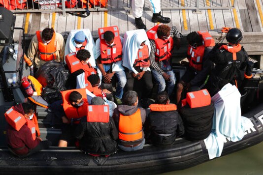 A group of people, thought to be migrants wait on a Border Force rib to come ashore at Dover marina in Kent, England after a small boat incident in the English Channel, Tuesday Sept. 22, 2020. (Gareth Fuller/PA via AP) A group of people, thought to be migrants wait on a Border Force rib to come ashore at Dover marina in Kent, England after a small boat incident in the English Channel, Tuesday Sept. 22, 2020. (Gareth Fuller/PA via AP)