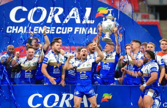 Leeds Rhinos celebrate with the trophy after the Challenge Cup Final at Wembley Stadium, in London, Saturday, Oct. 17, 2020. Leeds Rhinos won English rugby leagues Challenge Cup for the 14th time by beating Salford Red Devils 17-16 thanks to a drop goal five minutes from the time at a deserted Wembley Stadium. It was a poignant victory for Leeds, whose former player Rob Burrow was an absent chief guest for the match after after being diagnosed with motor neurone disease two years after ending his illustrious playing career in 2017. (Mike Egerton/PA via AP) Leeds Rhinos celebrate with the trophy after the Challenge Cup Final at Wembley Stadium, in London, Saturday, Oct. 17, 2020. Leeds Rhinos won English rugby leagues Challenge Cup for the 14th time by beating Salford Red Devils 17-16 thanks to a drop goal five minutes from the time at a deserted Wembley Stadium. It was a poignant victory for Leeds, whose former player Rob Burrow was an absent chief guest for the match after after being diagnosed with motor neurone disease two years after ending his illustrious playing career in 2017. (Mike Egerton/PA via AP)