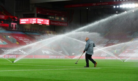 A groundsman works on the pitch ahead of the English League Cup fourth round soccer match between Liverpool and Arsenal at Anfield, Liverpool, England, Thursday, Oct. 1, 2020. (Peter Byrne/Pool via AP) A groundsman works on the pitch ahead of the English League Cup fourth round soccer match between Liverpool and Arsenal at Anfield, Liverpool, England, Thursday, Oct. 1, 2020. (Peter Byrne/Pool via AP)