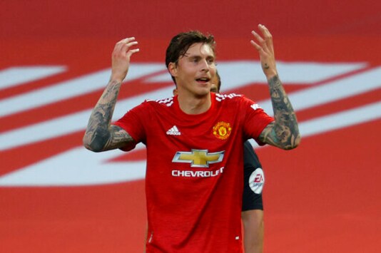 Manchester United's Victor Lindelof reacts after a penalty is awarded to Crystal Palace upon VAR review during the English Premier League soccer match between Manchester United and Crystal Palace at the Old Trafford stadium in Manchester, England, Saturday, Sept. 19, 2020. (Richard Heathcote/Pool via AP)
