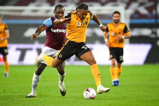 Wolverhampton Wanderers' Adama Traore, right, battles for the ball with West Ham's Angelo Ogbonna during the English Premier League soccer match between West Ham and Wolverhampton Wanderers at London Stadium, London, England, Sunday, Sept. 27, 2020. (Andy Rain/Pool via AP)