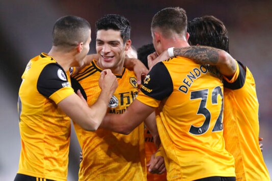 Wolverhampton Wanderers' Raul Jimenez, second left, celebrates after scoring his side's opening goal during the English Premier League soccer match between Wolves and Newcastle United at Molineux Stadium in Wolverhampton, England, Sunday, Oct. 25, 2020. (Alex Pantling/Pool Photo via AP)