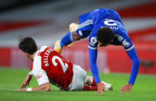 Leicester's James Justin falls as he is tackled by Arsenal's Hector Bellerin during the English Premier League soccer match between Arsenal and Leicester City at Emirates Stadium in London, England, Sunday, Oct. 25, 2020. (AP Photo/Ian Walton,Pool) Leicester's James Justin falls as he is tackled by Arsenal's Hector Bellerin during the English Premier League soccer match between Arsenal and Leicester City at Emirates Stadium in London, England, Sunday, Oct. 25, 2020. (AP Photo/Ian Walton,Pool)
