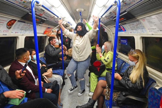 People ride a Northern Line train in London after the 10 p.m. curfew pubs and restaurants are subject to in order to combat the rise in coronavirus cases in England, on Saturday Oct. 3, 2020. (Victoria Jones/PA via AP) People ride a Northern Line train in London after the 10 p.m. curfew pubs and restaurants are subject to in order to combat the rise in coronavirus cases in England, on Saturday Oct. 3, 2020. (Victoria Jones/PA via AP)