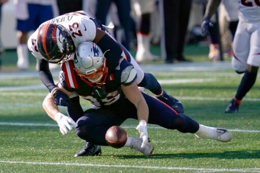 New England Patriots tight end Ryan Izzo, below, fumbles as Denver Broncos cornerback Michael Ojemudia (23) tackles him in the second half of an NFL football game, Sunday, Oct. 18, 2020, in Foxborough, Mass. (AP Photo/Charles Krupa) New England Patriots tight end Ryan Izzo, below, fumbles as Denver Broncos cornerback Michael Ojemudia (23) tackles him in the second half of an NFL football game, Sunday, Oct. 18, 2020, in Foxborough, Mass. (AP Photo/Charles Krupa)
