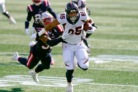 Denver Broncos tight end Albert Okwuegbunam (85) tries to run away from New England Patriots defensive back Kyle Dugger, left, after catching a pass in the first half of an NFL football game, Sunday, Oct. 18, 2020, in Foxborough, Mass. (AP Photo/Steven Senne) Denver Broncos tight end Albert Okwuegbunam (85) tries to run away from New England Patriots defensive back Kyle Dugger, left, after catching a pass in the first half of an NFL football game, Sunday, Oct. 18, 2020, in Foxborough, Mass. (AP Photo/Steven Senne)