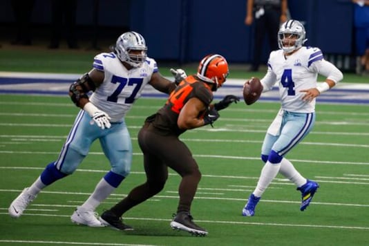 Dallas Cowboys offensive tackle Tyron Smith (77) defends against pressure from Cleveland Browns defensive end Olivier Vernon (54) as quarterback Dak Prescott (4) looks to make a pass in the first half of an NFL football game in Arlington, Texas, Sunday, Oct. 4, 2020. (AP Photo/Ron Jenkins) Dallas Cowboys offensive tackle Tyron Smith (77) defends against pressure from Cleveland Browns defensive end Olivier Vernon (54) as quarterback Dak Prescott (4) looks to make a pass in the first half of an NFL football game in Arlington, Texas, Sunday, Oct. 4, 2020. (AP Photo/Ron Jenkins)