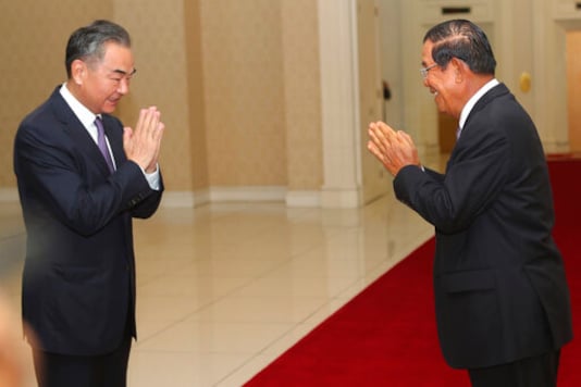 Chinese Foreign Minister Wang Yi, left, greets Cambodian Prime Minister Hun Sen prior to a meeting at Peace Palace in Phnom Penh, Cambodia, Monday, Oct. 12, 2020. The two countries signed a free trade agreement on Monday. (AP Photo/Heng Sinith) Chinese Foreign Minister Wang Yi, left, greets Cambodian Prime Minister Hun Sen prior to a meeting at Peace Palace in Phnom Penh, Cambodia, Monday, Oct. 12, 2020. The two countries signed a free trade agreement on Monday. (AP Photo/Heng Sinith)
