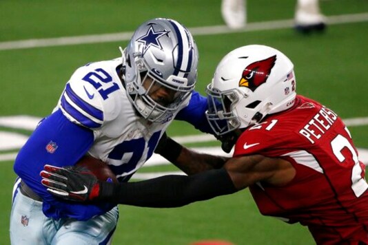 Dallas Cowboys' Ezekiel Elliott (21) gains a first down running the ball against Arizona Cardinals' Patrick Peterson, right, in the second half of an NFL football game in Arlington, Texas, Monday, Oct. 19, 2020. (AP Photo/Michael Ainsworth) Dallas Cowboys' Ezekiel Elliott (21) gains a first down running the ball against Arizona Cardinals' Patrick Peterson, right, in the second half of an NFL football game in Arlington, Texas, Monday, Oct. 19, 2020. (AP Photo/Michael Ainsworth)
