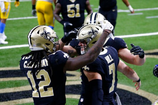 New Orleans Saints quarterback Taysom Hill (7) celebrates his touchdown with wide receiver Marquez Callaway (12) in the second half of an NFL football game against the Los Angeles Chargers in New Orleans, Monday, Oct. 12, 2020. (AP Photo/Butch Dill) New Orleans Saints quarterback Taysom Hill (7) celebrates his touchdown with wide receiver Marquez Callaway (12) in the second half of an NFL football game against the Los Angeles Chargers in New Orleans, Monday, Oct. 12, 2020. (AP Photo/Butch Dill)