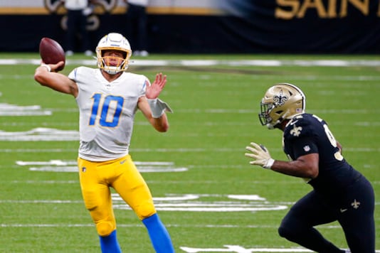 Los Angeles Chargers quarterback Justin Herbert (10) passes under pressure from New Orleans Saints defensive end Cameron Jordan (94) in the first half of an NFL football game in New Orleans, Monday, Oct. 12, 2020. (AP Photo/Butch Dill) Los Angeles Chargers quarterback Justin Herbert (10) passes under pressure from New Orleans Saints defensive end Cameron Jordan (94) in the first half of an NFL football game in New Orleans, Monday, Oct. 12, 2020. (AP Photo/Butch Dill)