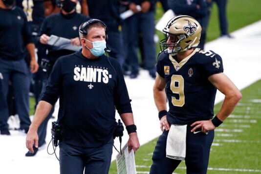 New Orleans Saints head coach Sean Payton talks with quarterback Drew Brees (9) in the first half of an NFL football game against the Los Angeles Chargers in New Orleans, Monday, Oct. 12, 2020. (AP Photo/Butch Dill)