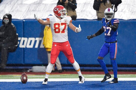 Kansas City Chiefs' Travis Kelce, left, celebrates his touchdown as Buffalo Bills' Tre'Davious White, right, looks on, during the first half of an NFL football game, Monday, Oct. 19, 2020, in Orchard Park, N.Y. (AP Photo/Adrian Kraus)