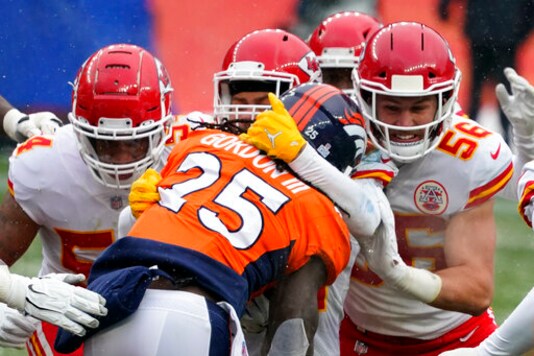 Denver Broncos running back Melvin Gordon (25) is brought down by Kansas City Chiefs linebacker Ben Niemann (56) and others during the first half of an NFL football game Sunday, Oct. 25, 2020, in Denver. (AP Photo/Jack Dempsey)
