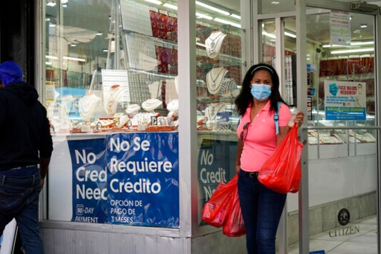 A woman walks out of the Gold City of St. Nicholas jewelry store, in New York, Friday, Sept. 25, 2020. (AP Photo/Mark Lennihan) A woman walks out of the Gold City of St. Nicholas jewelry store, in New York, Friday, Sept. 25, 2020. (AP Photo/Mark Lennihan)
