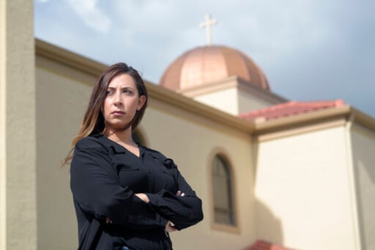 Sally Zakhari stands in front of the St. Mary & Archangel Michael Coptic Orthodox Church, Monday, Aug. 24, 2020, in Oviedo, Fla. Zakhari has alleged, including in a police report and to Coptic Church officials, that a Coptic priest visiting Florida in the late 1990s, Reweis Aziz Khalil, sexually abused her when she was 11 or 12. Khalil was stripped of his priesthood in July; he denied the allegations through his attorney. (AP Photo/Phelan M. Ebenhack) Sally Zakhari stands in front of the St. Mary & Archangel Michael Coptic Orthodox Church, Monday, Aug. 24, 2020, in Oviedo, Fla. Zakhari has alleged, including in a police report and to Coptic Church officials, that a Coptic priest visiting Florida in the late 1990s, Reweis Aziz Khalil, sexually abused her when she was 11 or 12. Khalil was stripped of his priesthood in July; he denied the allegations through his attorney. (AP Photo/Phelan M. Ebenhack)