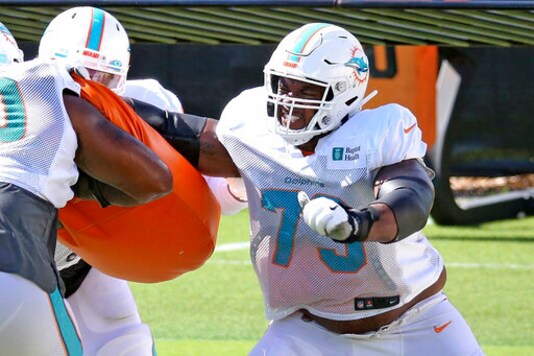 FILE - Miami Dolphins rookie tackle Austin Jackson (73) runs a drill during NFL football training camp Monday, Aug. 31, 2020, in Miami. At least four Miami Dolphins rookies are expected to see significant action in Sundays, Sept. 13 opener. (Charles Trainor Jr./Miami Herald via AP, File)