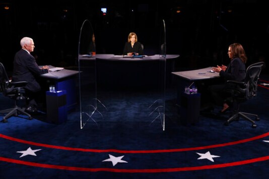 Vice President Mike Pence listens as Democratic vice presidential candidate Sen. Kamala Harris, D-Calif., speaks during the vice presidential debate Wednesday, Oct. 7, 2020, at Kingsbury Hall on the campus of the University of Utah in Salt Lake City. (Justin Sullivan/Pool via AP) Vice President Mike Pence listens as Democratic vice presidential candidate Sen. Kamala Harris, D-Calif., speaks during the vice presidential debate Wednesday, Oct. 7, 2020, at Kingsbury Hall on the campus of the University of Utah in Salt Lake City. (Justin Sullivan/Pool via AP)